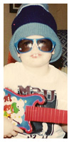 With his guitar and sunglasses. Age 4. He never changed.